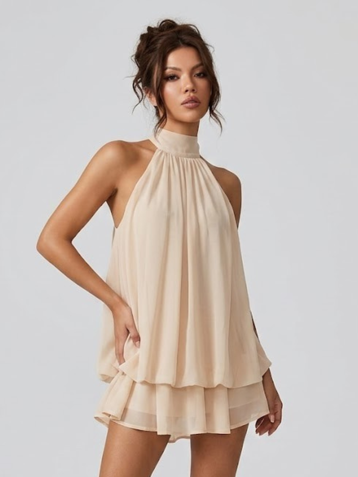 Vestito corto da donna con collo alto all'americana, schiena nuda e volant a balze