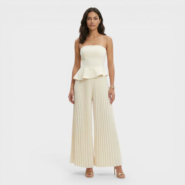 Tuta da donna color crema con bustier con baschina e gamba ampia plissettata