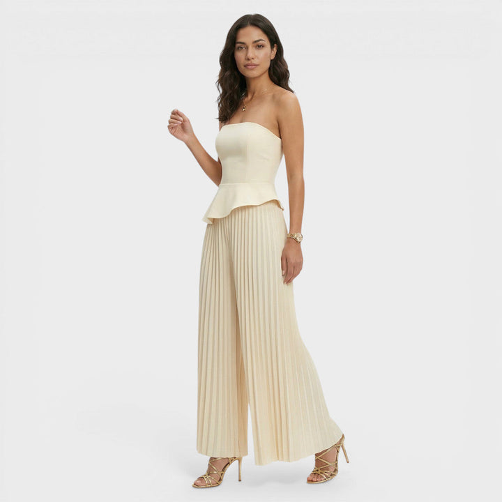 Tuta da donna color crema con bustier con baschina e gamba ampia plissettata