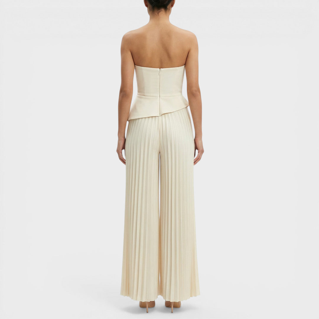 Tuta da donna color crema con bustier con baschina e gamba ampia plissettata