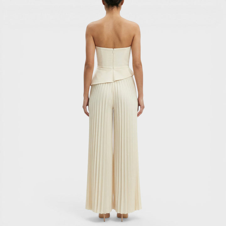 Tuta da donna color crema con bustier con baschina e gamba ampia plissettata