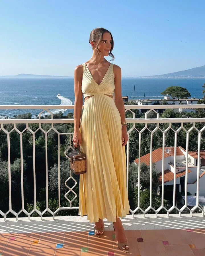 Vestito lungo giallo con scollo profondo e pieghe