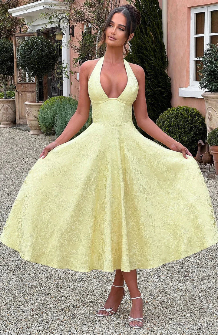 Abito midi donna giallo schiena nuda con gonna plissettata