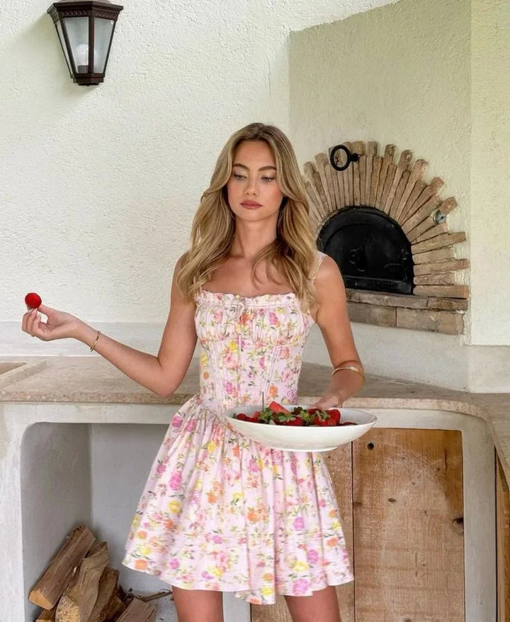 Vestito corto rosa a fiori con corsetto e spalline larghe